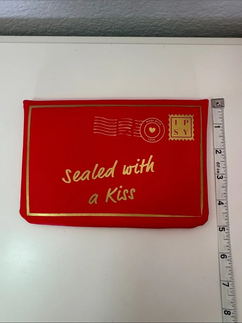 This is a red Ipsy Sealed with a Kiss makeup bag NWOT